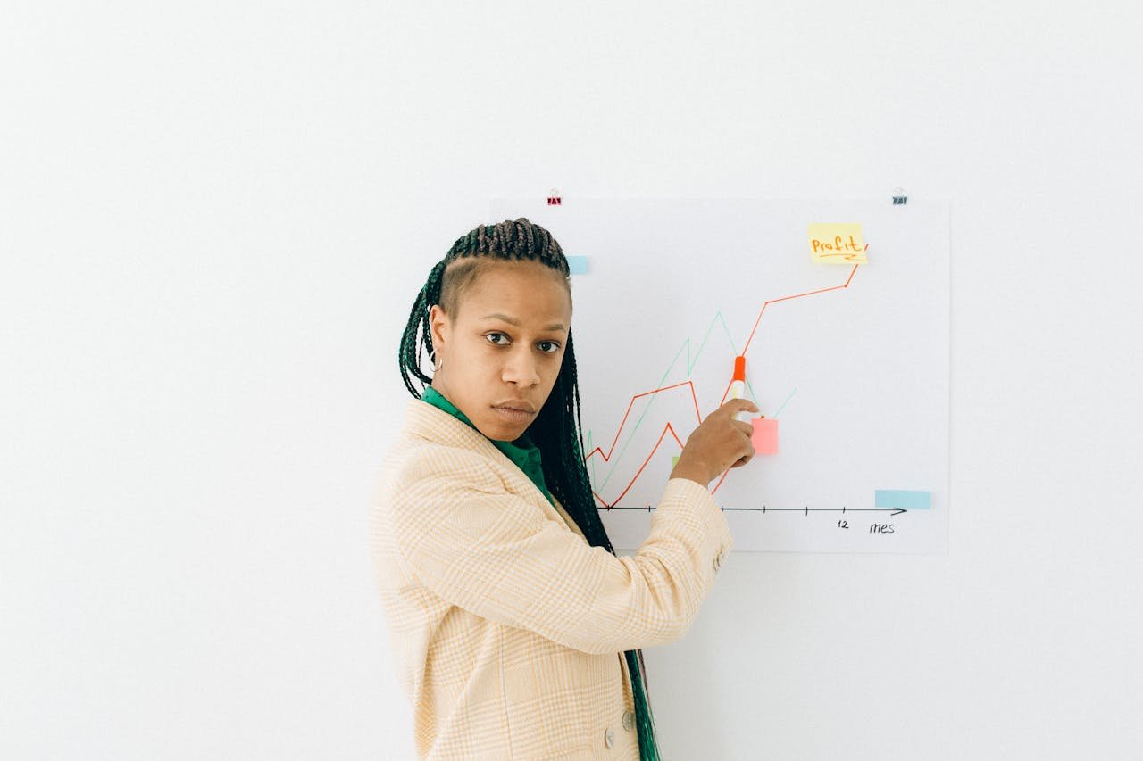 Woman In Beige And Black Long Sleeve Shirt Holding Red Pen 7172984